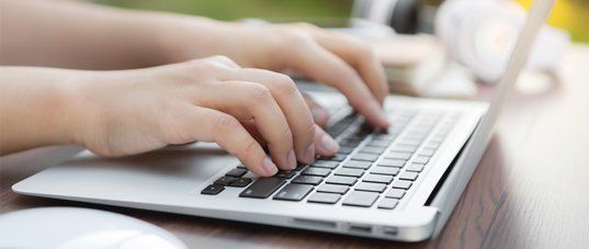 Patient reviewing dental forms on a laptop